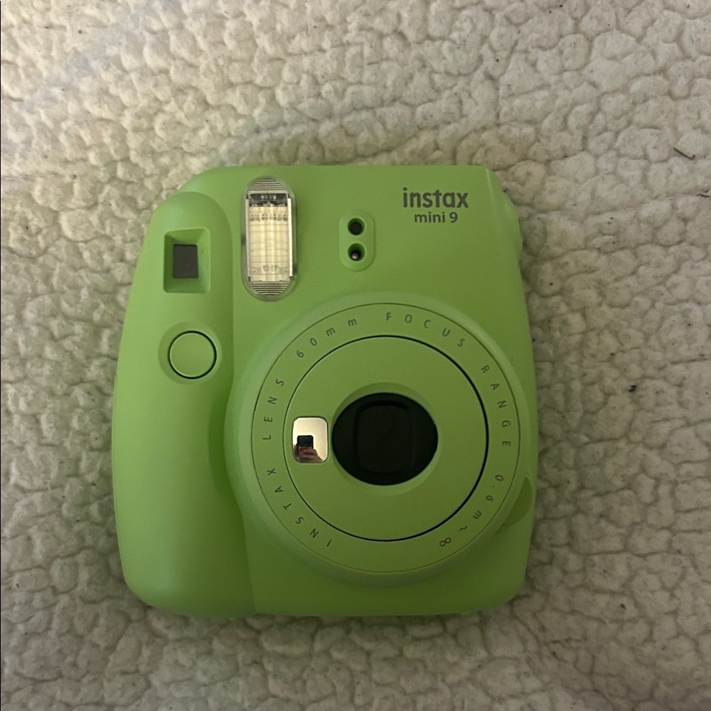 Green Instax polaroid camera